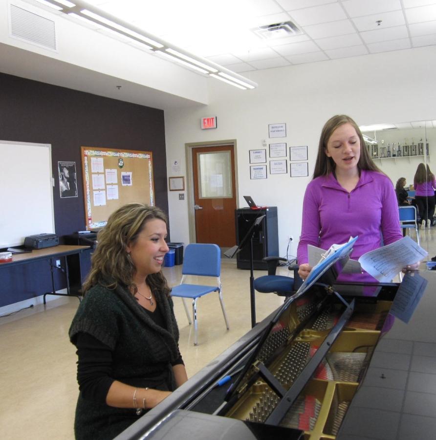 Pramstaller works through a piece of choral music with junior Michelle Pawlow.